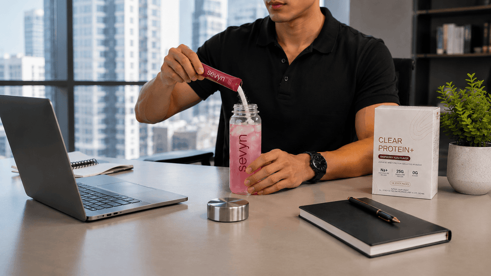 Pouring into a tumbler at the office — wide shot